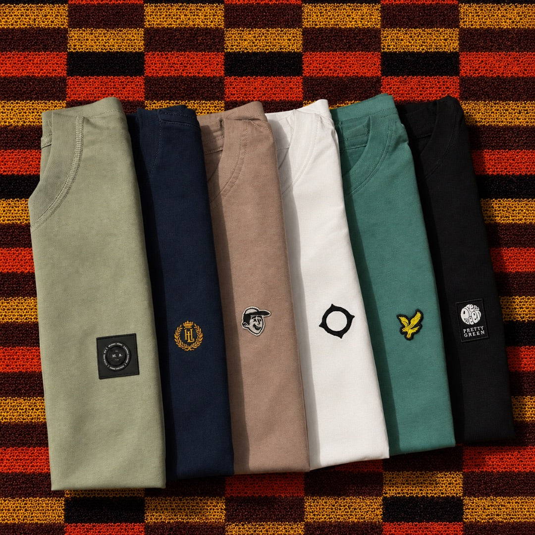 Folded terrace-culture knitwear and sweatshirts from Artifacts Apparel on a checkered blanket